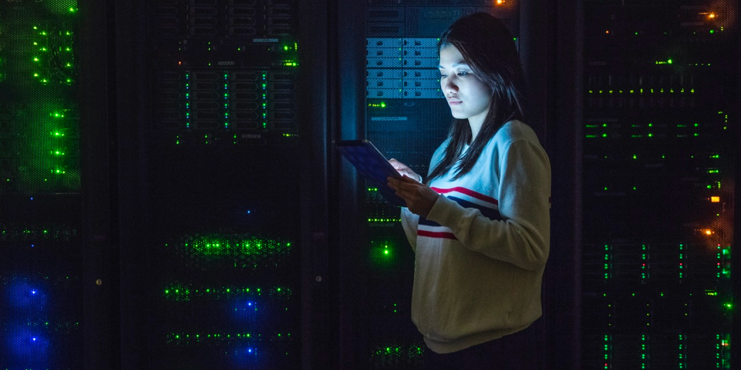 Une femme travaille sur une tablette numérique au sein d’une base de données. 